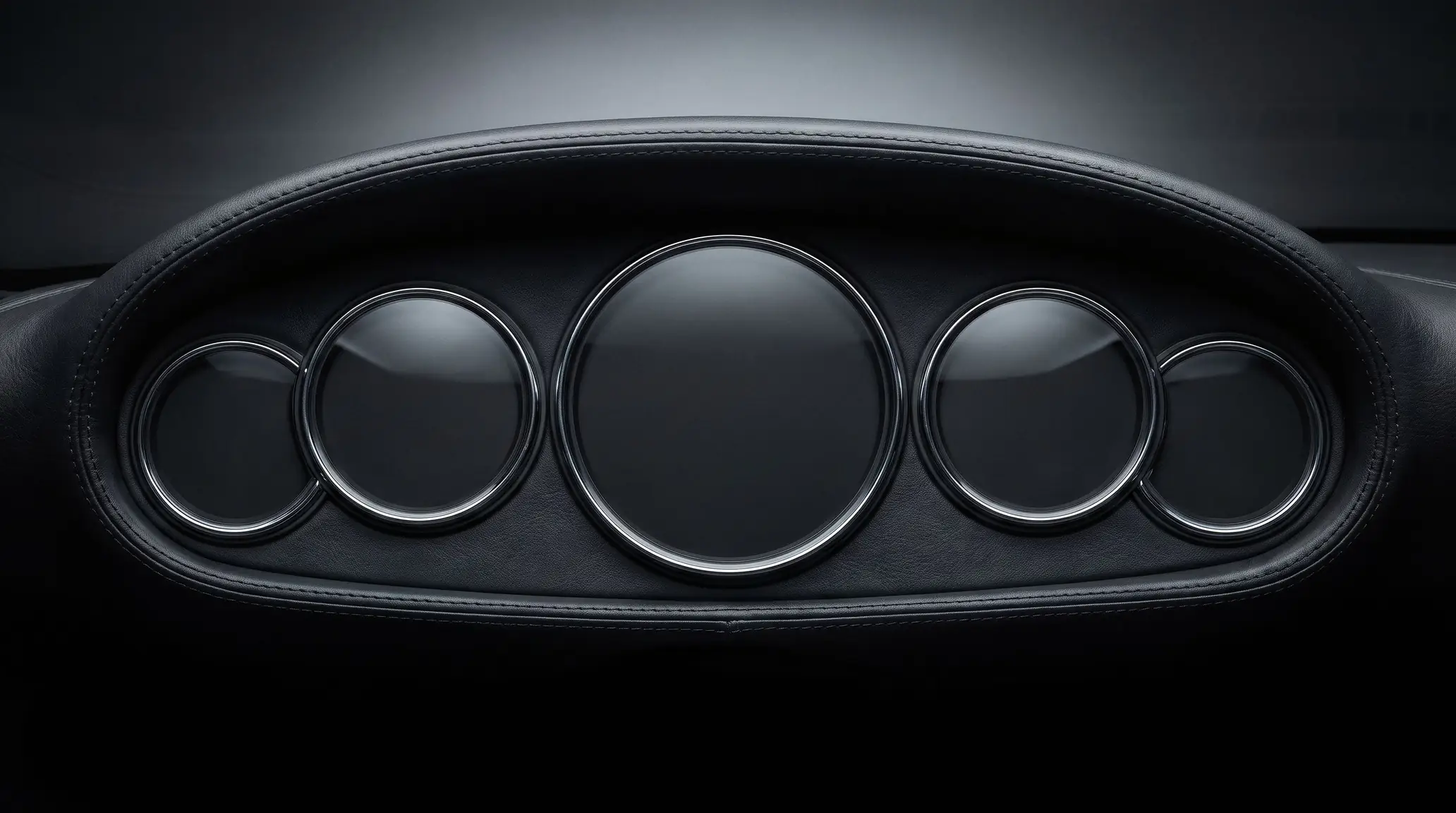 Classic five-dial sports car instrument cluster under a leather hood